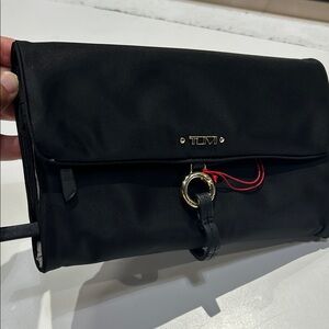 NWT Tumi Black jewelry roll Bag with Gold hardware.